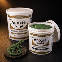Aves Apoxie Sculpt 4lb Green — large Part A and Part B tubs with green putty visible, alongside a detailed sculpted lizard on a rock base