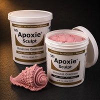 Aves Apoxie Sculpt 4lb Pink — large Part A and Part B tubs with pink putty visible, alongside a detailed sculpted ornate spiral seashell