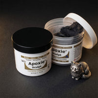 Aves Studio Apoxie Sculpt Black modelling compound with Part A and Part B jars beside a small black cat sculpture