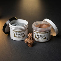 Aves Studio Apoxie Sculpt Bronze 1 lb with Part A and Part B jars beside a bronze fantasy bust sculpture