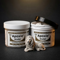Aves Studio Apoxie Sculpt Stone Grey modelling compound with Part A and Part B jars beside a stone grey lion sculpture