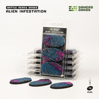 Gamers Grass packaging and three painted 75mm oval Alien Infestation bases displayed on white background