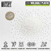 White moldable thermoplastic beads shown next to a coin for size reference