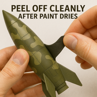 Peeling off elastic masking putty from painted surface – demonstrating clean removal after airbrushing