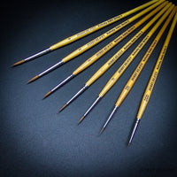 Series 4 Kolinsky Sable complete size range — sizes 000 to 4 with natural birch handles on dark background