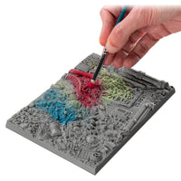 Using drybrush technique on textured palette board before applying paint to miniature model
