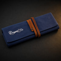 Rosemary & Co large navy fabric brush wrap shown closed with leather strap and embroidered logo