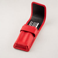 Open Rosemary & Co red leather 3 pocket brush wallet showing short travel brushes stored in individual pockets