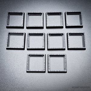 Ten base converters 20mm to 25mm square displayed in group on dark surface
