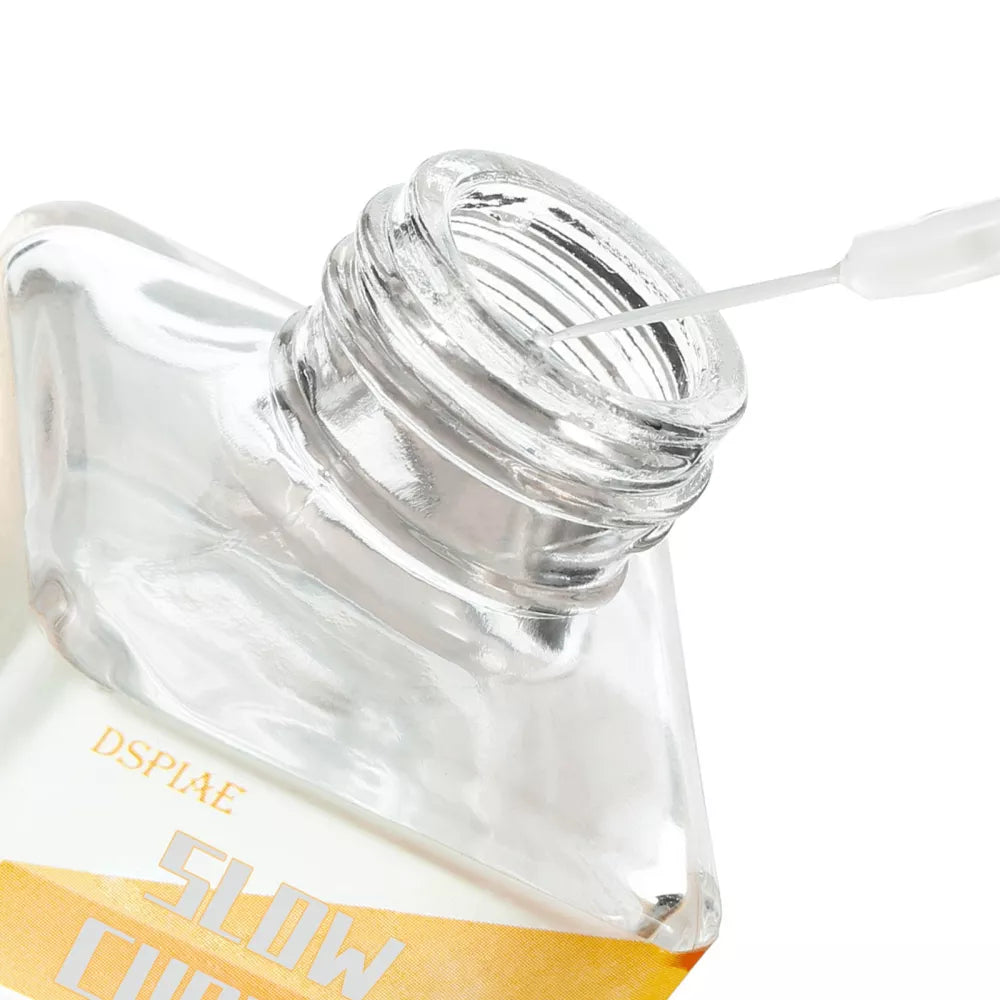 Close-up of the open Slow Curing Cement bottle neck with the fine white applicator from the cap