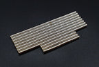 Two overlapping groups of stacked 2 x 1 mm neodymium disc magnets on a dark background
