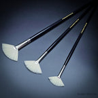 Three Rosemary & Co Ivory fan brushes laid diagonally with gold-printed black handles, sizes 2 to 6