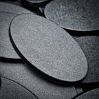 Macro view of a 60x35mm oval plain base, the fine stipple texture of the top face filling the frame