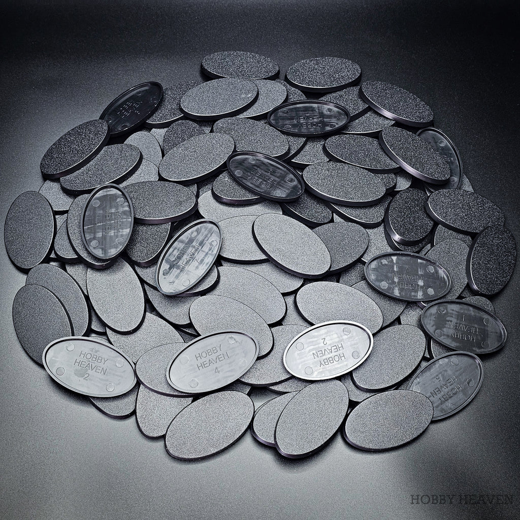 Cluster of 60x35mm oval plain plastic bases seen from above, edges and textured tops in close view
