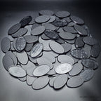 Cluster of 60x35mm oval plain plastic bases seen from above, edges and textured tops in close view