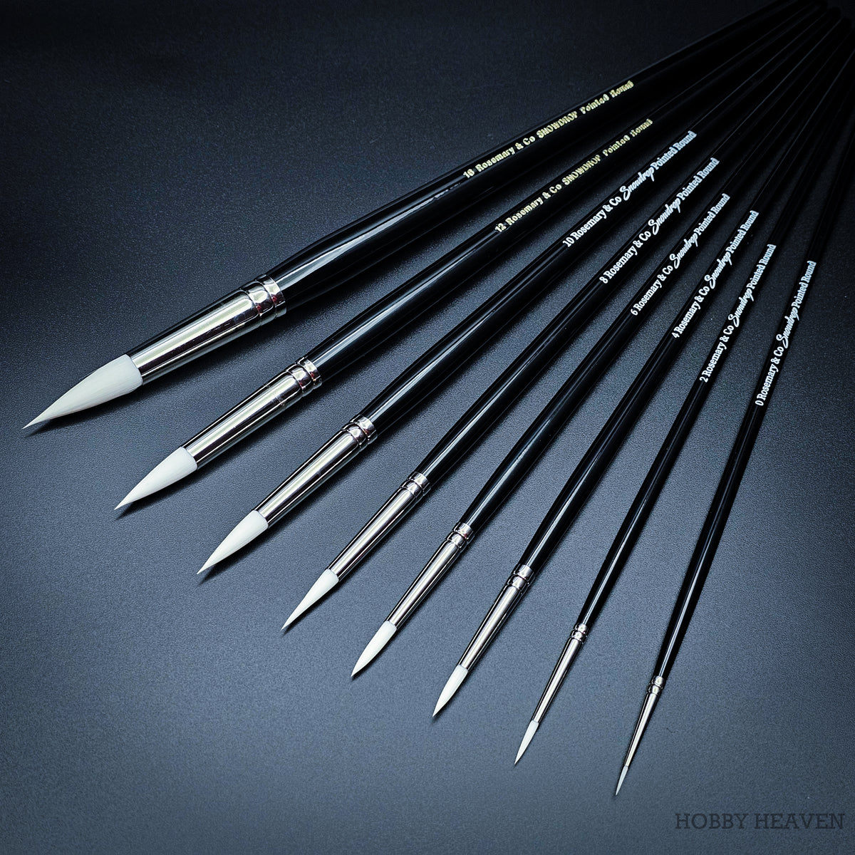 Full Rosemary & Co Snowdrop range — nine pointed round brushes in sizes 0 to 16 on short handles, white taklon bristles on black lacquered handles