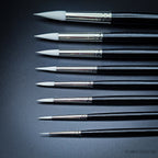 All nine Snowdrop sizes arranged showing brush heads from the side, comparing the progressive tuft width from size 0 to 16