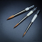 Three Pocket Kolinsky brushes from above showing white ferrule section and Kolinsky sable heads with handles extended