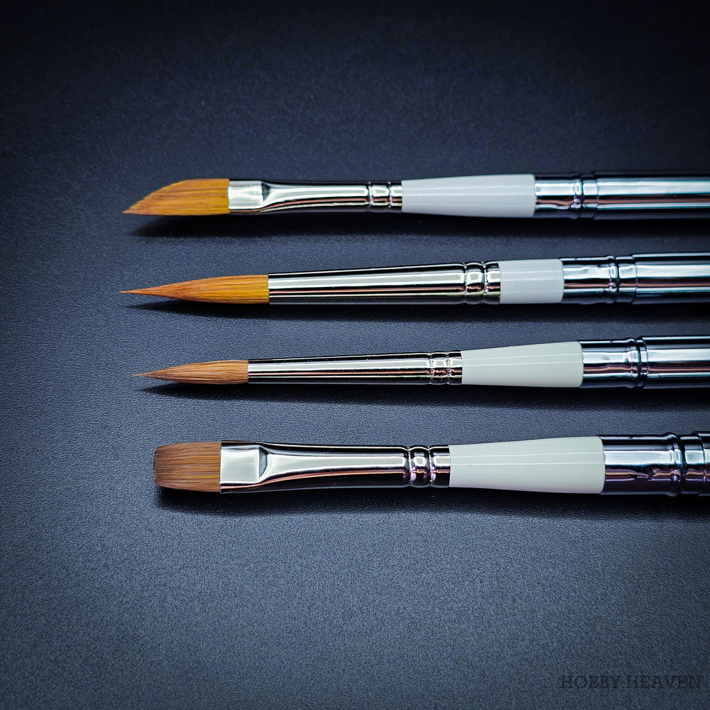 Close-up of four Set 35 brush heads side by side — dagger, Kolinsky pointed round, sable blend designer pointed and Red Dot short flat