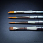 Close-up of four Set 35 brush heads side by side — dagger, Kolinsky pointed round, sable blend designer pointed and Red Dot short flat