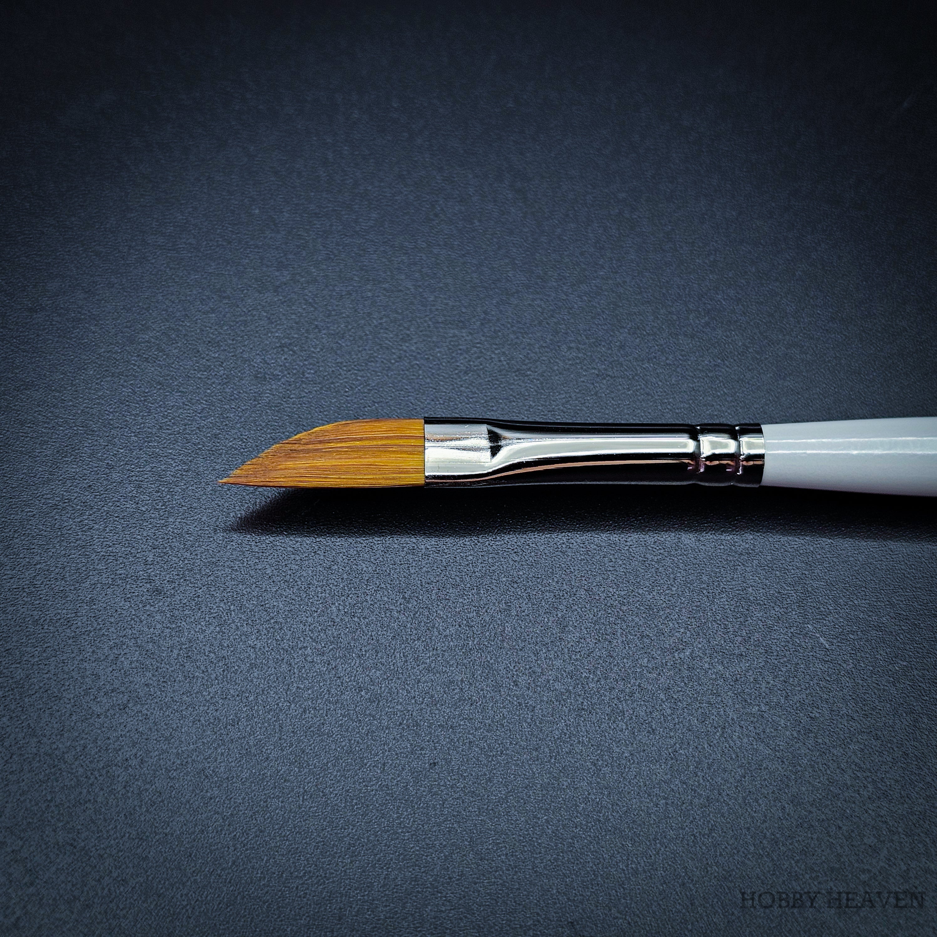 Close-up of R12 dagger brush head showing the angled sable-nylon blade with chrome ferrule