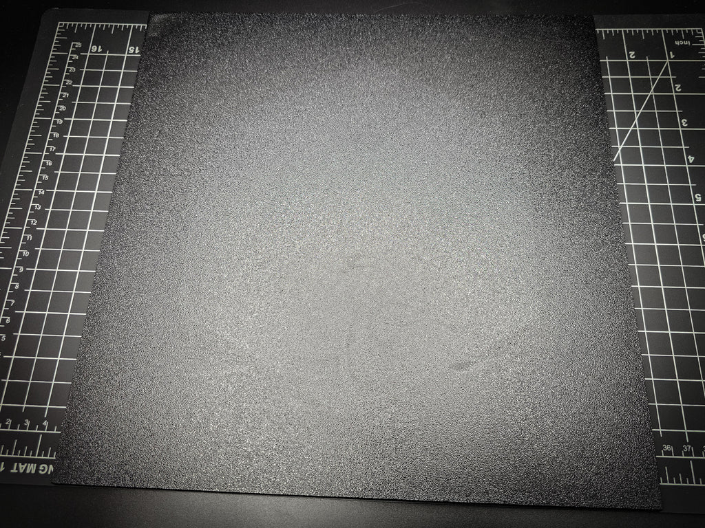 Top-down photograph of the 300mm square textured PETG base on a cutting mat, showing the rough matte surface nearly filling the entire mat.