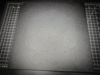 Top-down photograph of the 300mm square textured PETG base on a cutting mat, showing the rough matte surface nearly filling the entire mat.