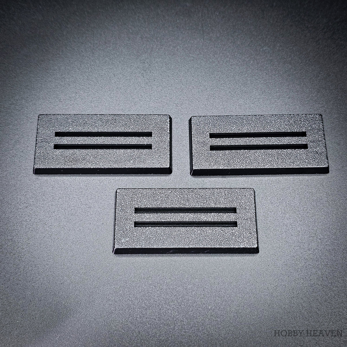 Three black 50x25mm rectangle slotted bases