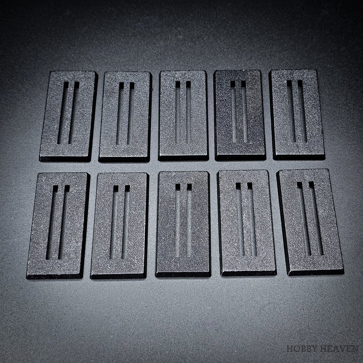 Ten black 50x25mm rectangle slotted bases in two rows