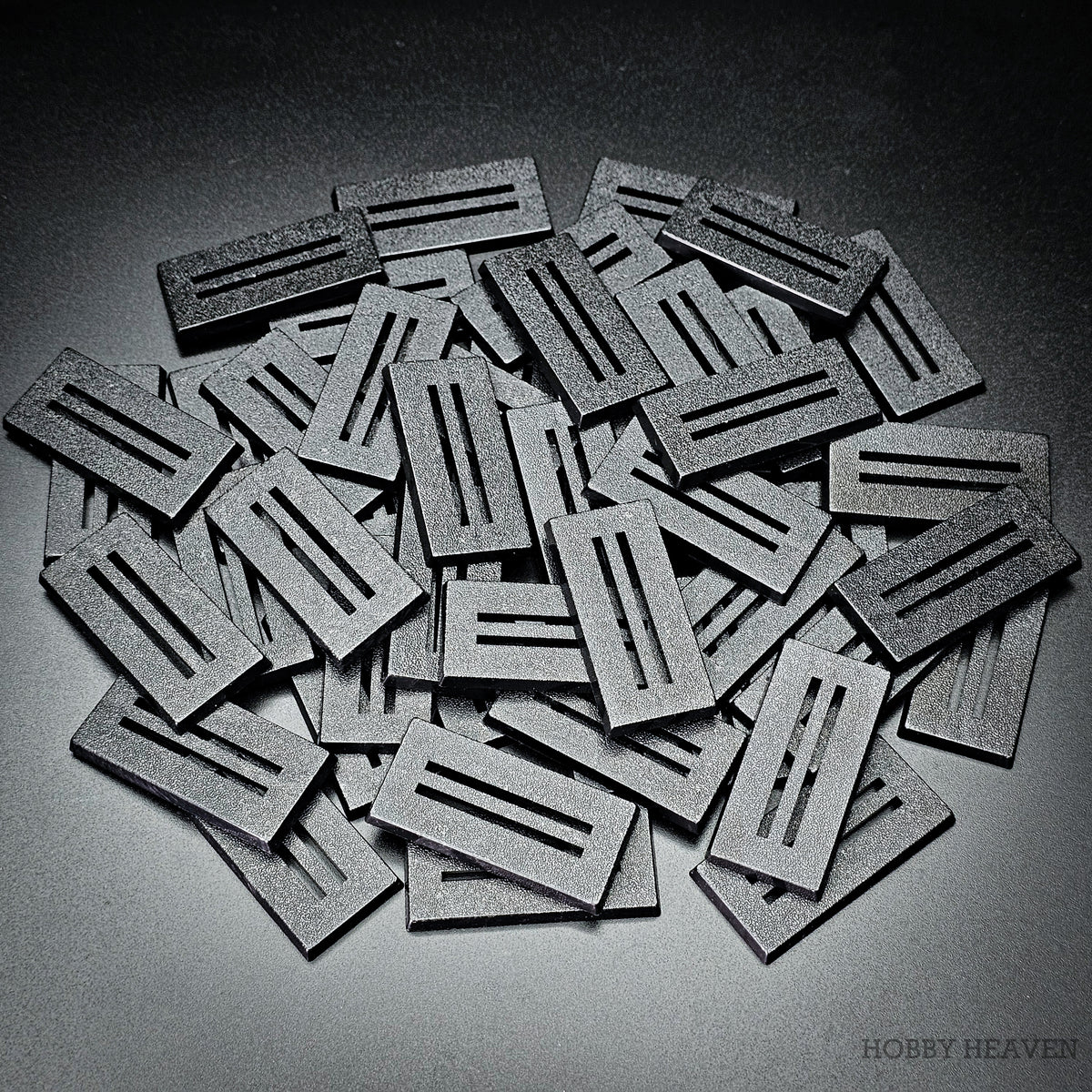 Pile of 50x25mm rectangle slotted bases with two parallel slots