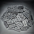 Heap of 50x25mm slotted bases, some turned over to show the open underside
