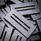 Detail of a 50x25mm slotted base: textured top, clean slot edges and bevelled rim