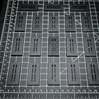 Rows of 50x25mm rectangle slotted bases on a centimetre cutting mat for scale