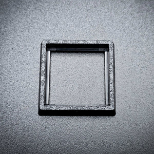 Single 20mm to 25mm square base converter on black background showing detail
