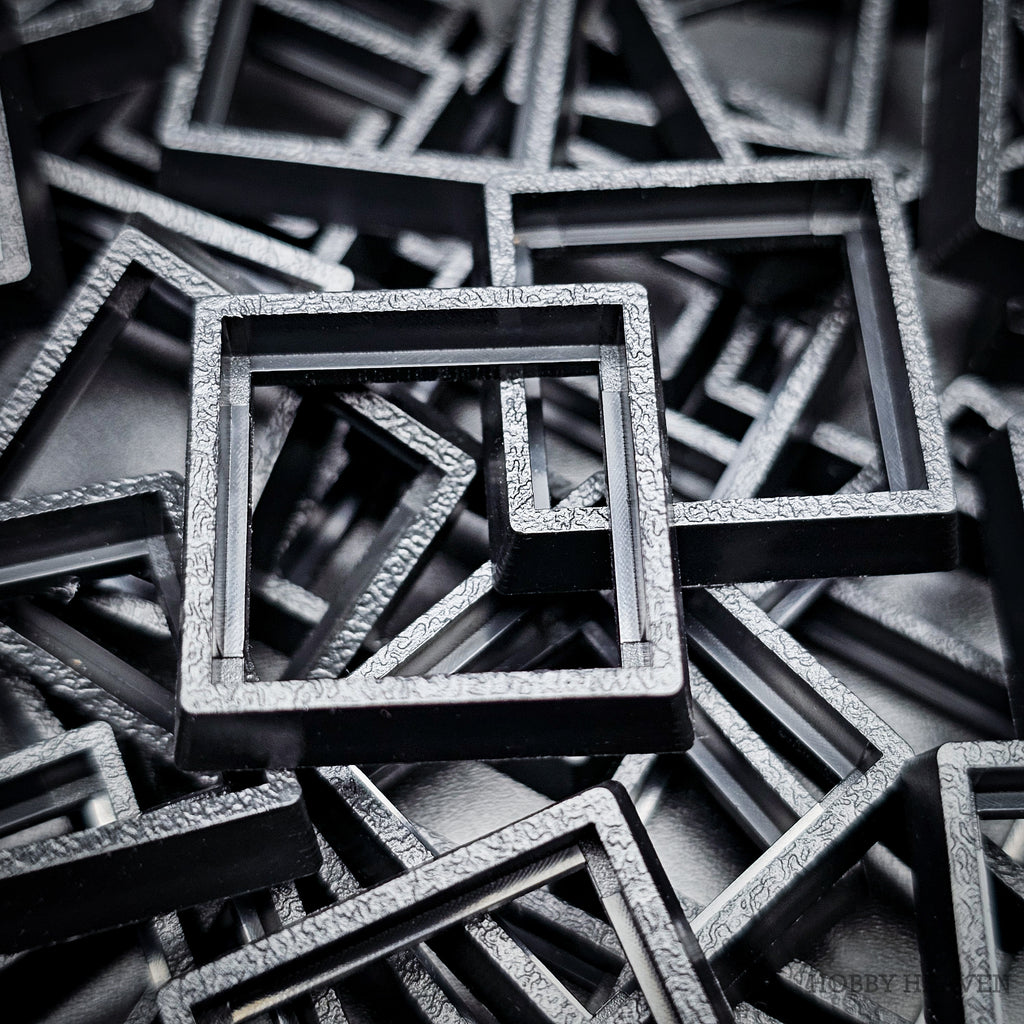Close-up of injection moulded base converters 20mm to 25mm square size