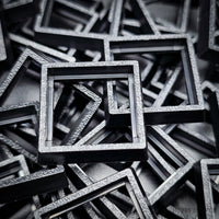 Close-up of injection moulded base converters 20mm to 25mm square size