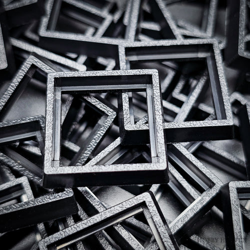 Close-up of injection moulded base converters 20mm to 25mm square size