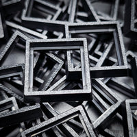 Close-up of injection moulded base converters 20mm to 25mm square size
