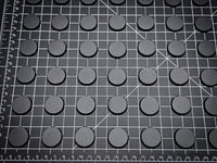 Set of 25mm round ABS plastic bases arranged in a grid, perfect for Warhammer 40k miniatures.
