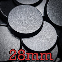 Close-up view of 28mm round bases, showcasing the smooth surface and precise circular shape for miniatures.
