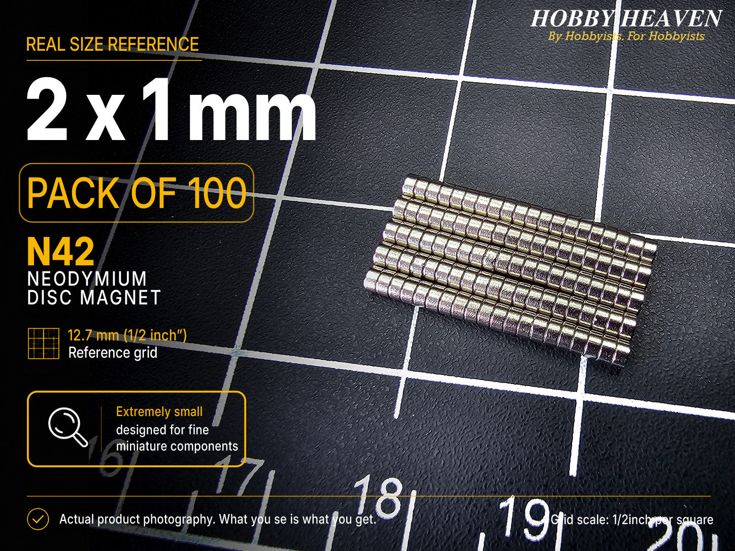 Pack of 100 - one hundred 2 x 1 mm N42 neodymium disc magnets in stacked rows on a half-inch reference grid