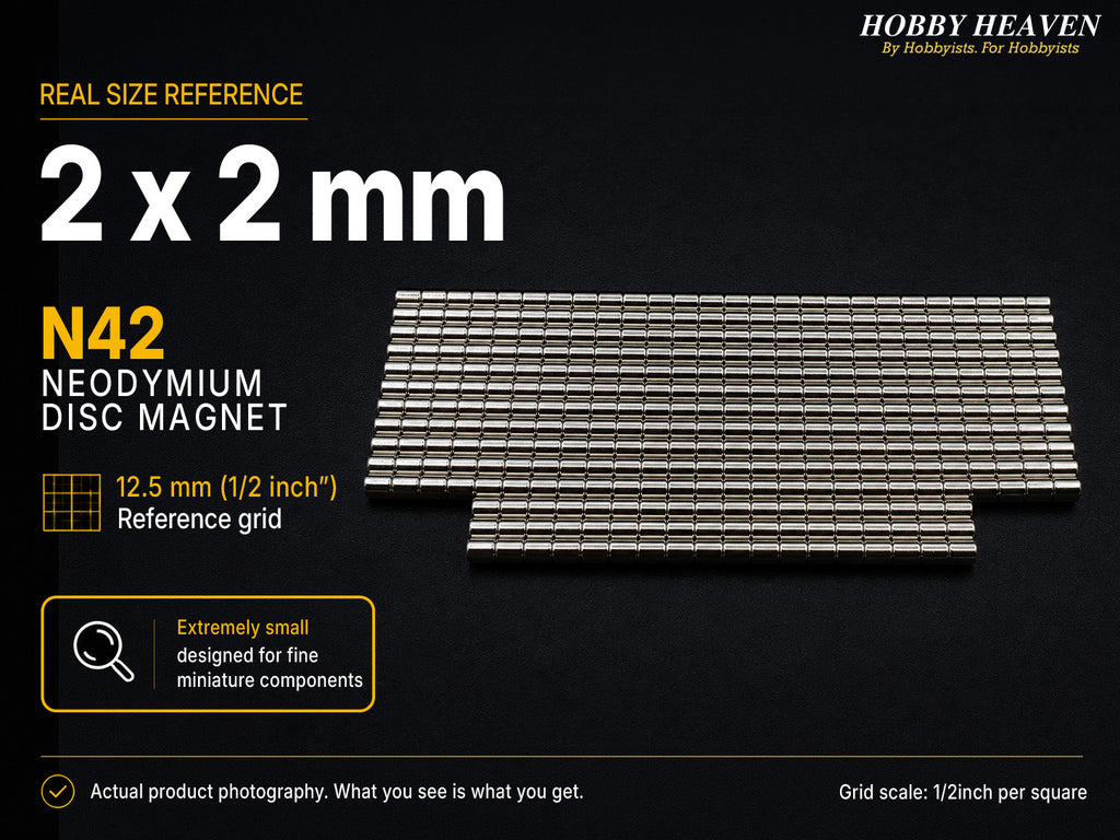 Stacked rows of 2 x 2 mm N42 neodymium disc magnets shown at real size on a half-inch reference grid