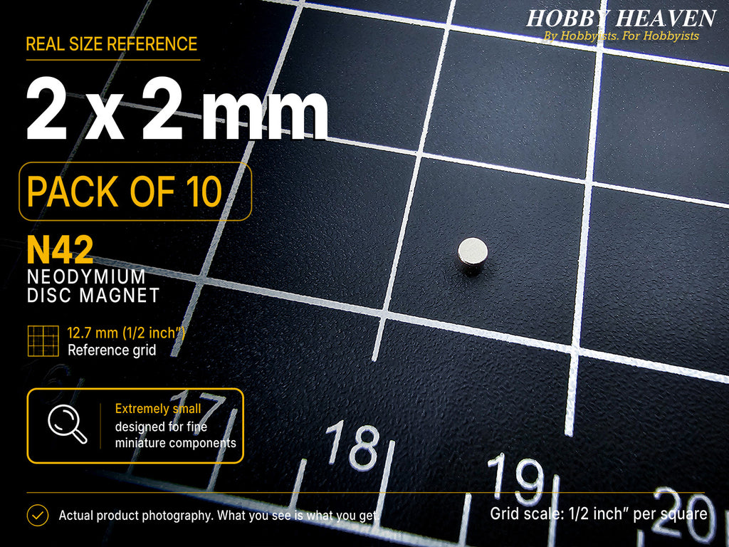 Single 2 x 2 mm N42 neodymium disc magnet shown at real size on a half-inch reference grid