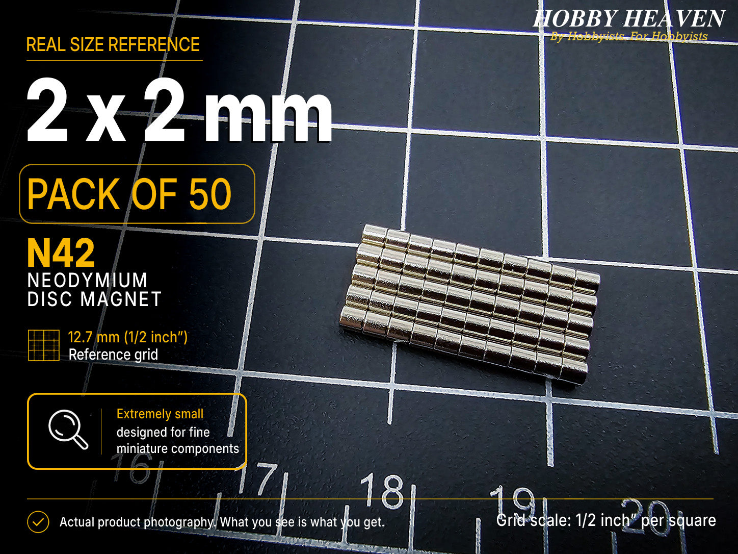 Pack of 50 - 2 x 2 mm N42 neodymium disc magnets in stacked rows on a half-inch reference grid