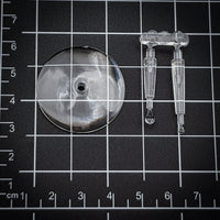 Clear acrylic 32mm flying base resting on a black modeler's cutting mat.
