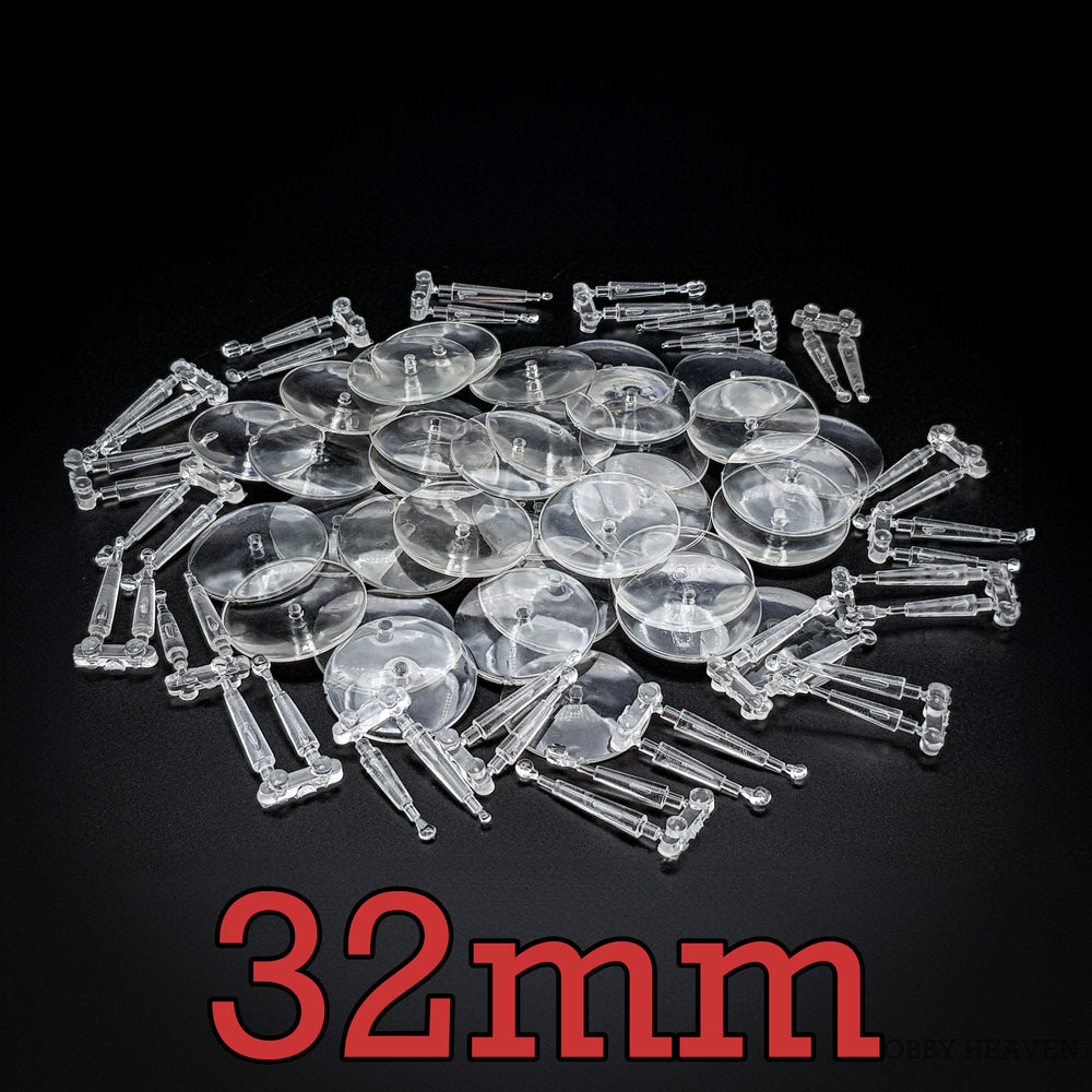 A stack of 32mm round flying bases made from clear acrylic on a black background.