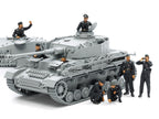 The figures posed on and beside a German tank, which is sold separately
