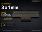 Stacked rows of 3 x 1 mm N42 neodymium disc magnets shown at real size on a half-inch reference grid