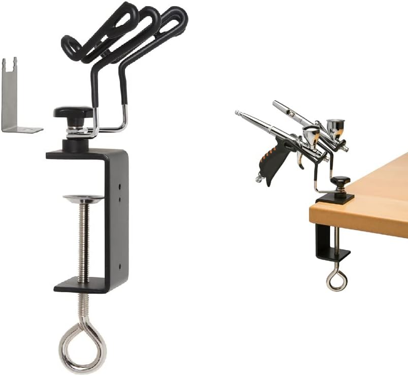 Iwata IWA-AH-400 holder with bracket and two airbrushes in the hangers, clamped to a table edge
