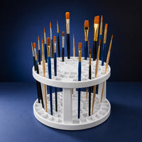 Folding brush holder holding paint brushes upright on a blue background
